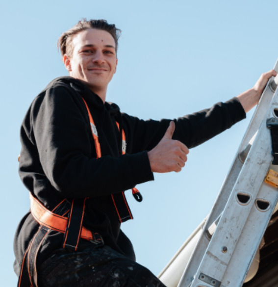 SPS Roofing specialist on ladder during roof restoration in Sydney